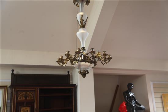 A 19th century French gilt metal and opaque glass twelve light chandelier, drop 3ft 1in. diameter 2ft 2in.